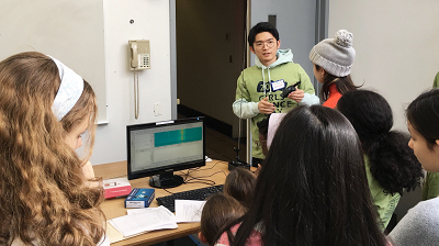 Tingjun Chen demonstrating the principles of wireless communications using a walkie-talkie at the Columbia Girls’ Science Day
