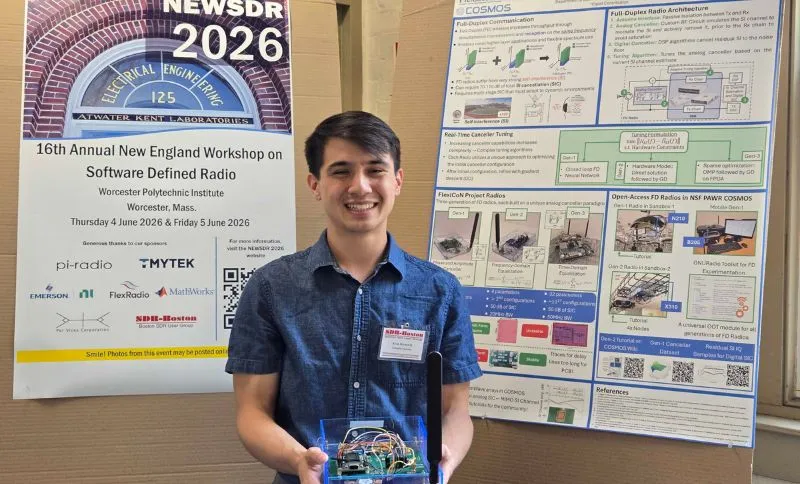 PhD Student Kevin Hermstein holding a FD radio alongside the poster.